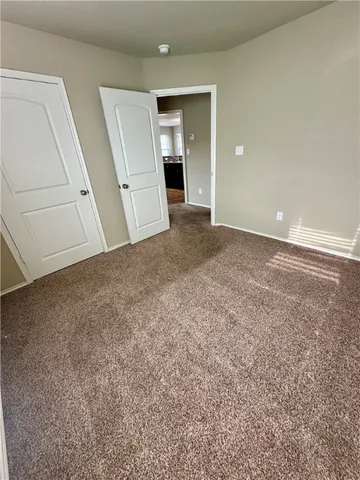 an empty room with an entryway and stairs