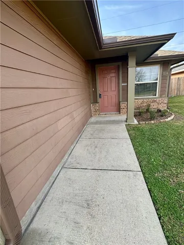 a view of backyard with patio