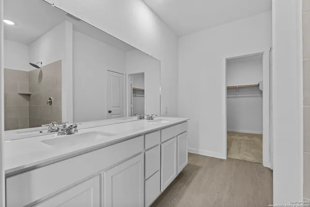 a bathroom with a sink double vanity and a mirror