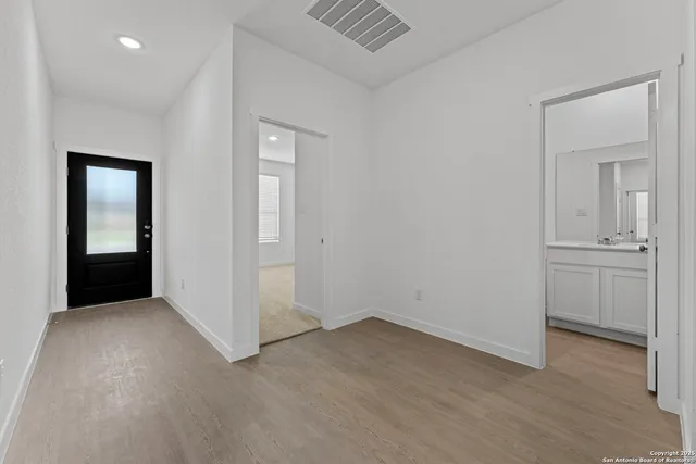 an empty room with windows and closet