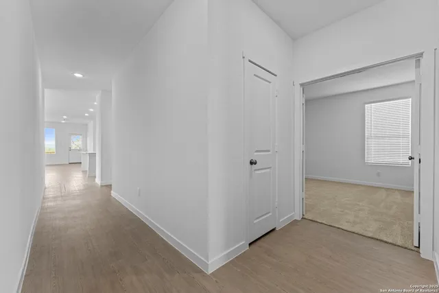 a view of a hallway with bathroom