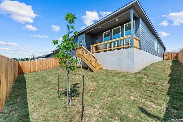 a view of balcony with small yard