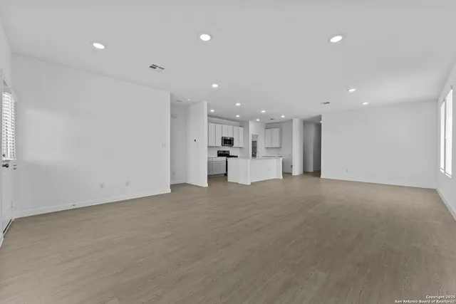 a view of a kitchen with a sink and a refrigerator