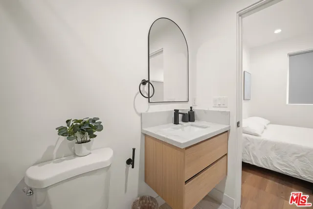 a bathroom with a sink toilet and a mirror