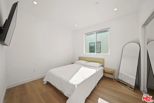 a bedroom with a bed and a large window