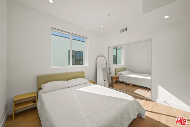 a bedroom with a bed and a chair