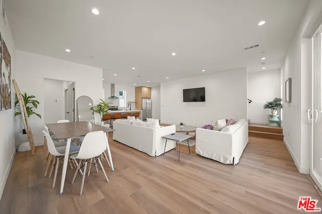 a living room with fireplace furniture and a wooden floor