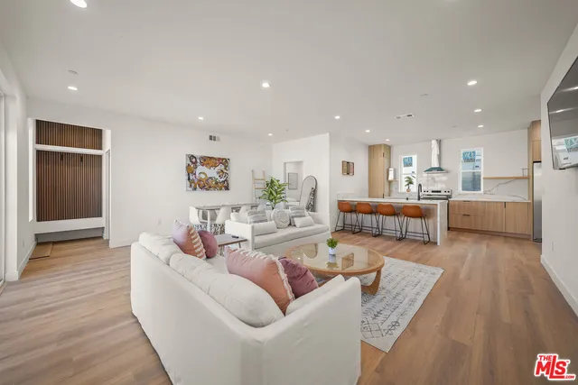 a living room with furniture and kitchen view
