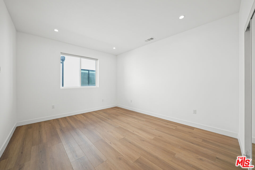 13692 Erwin Street, Unit A Van Nuys, CA 91401 - Photo 39 of 47 an empty room with wooden floor and windows