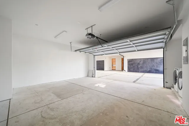a bedroom with a large bed and a painting on the wall