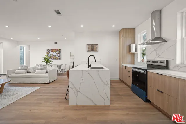 a living room with furniture and kitchen