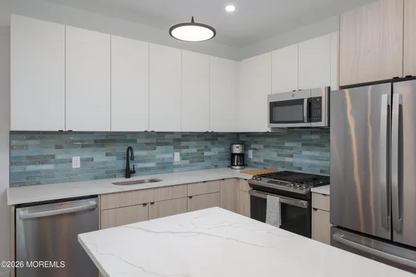 a kitchen with a sink a stove and refrigerator