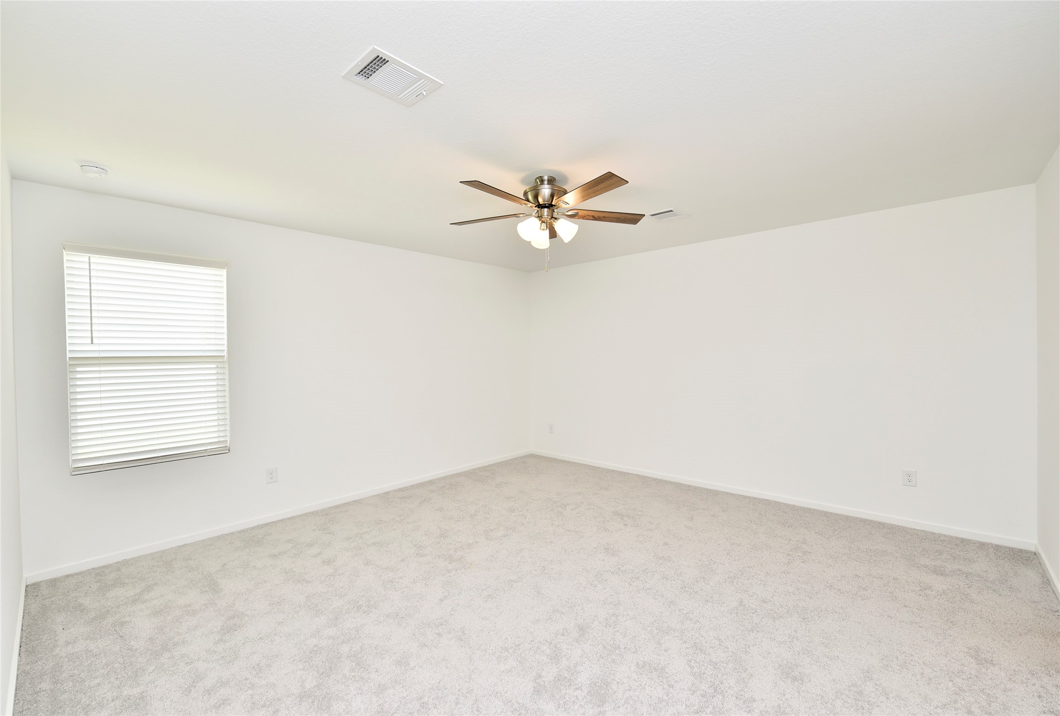 10218 Prairie Dunes Lane Cleveland, TX 77327 - Photo 16 of 32 an empty room with a window and a ceiling fan
