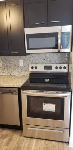 a stove top oven sitting inside of a kitchen