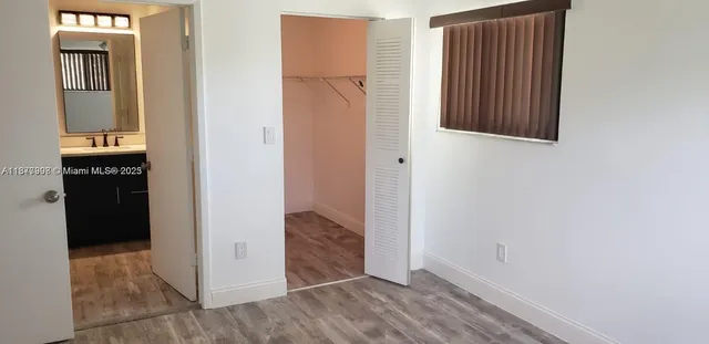 a view of an entryway with wooden floor