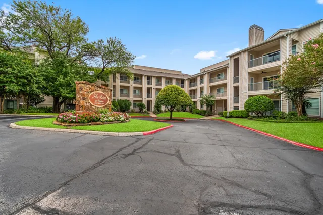 a view of a building with a yard and plants