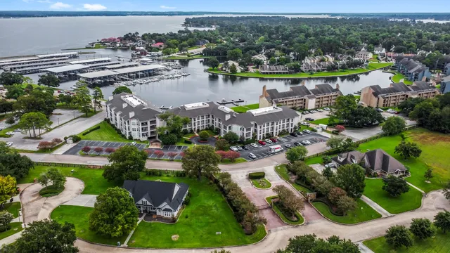 an aerial view of a house with a garden and lake view