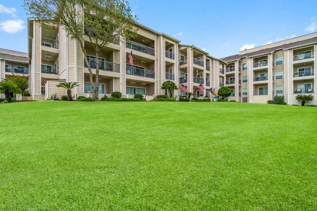 front view of a brick building with a yard