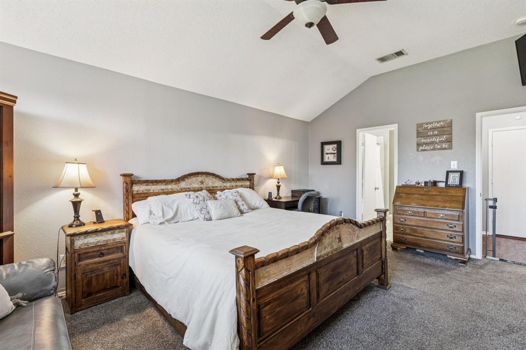 1421 Heather Ridge Drive Lancaster, TX 75146 - Photo 11 of 22 a bedroom with bed and a chandelier