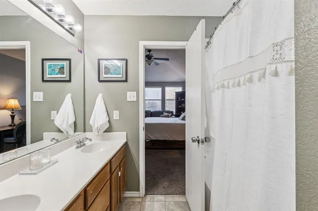 a bathroom with a double vanity sink and a mirror