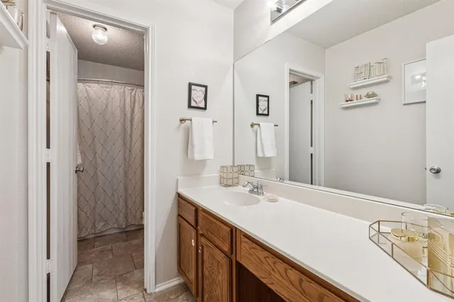 a bathroom with a double vanity sink a mirror and a bathtub