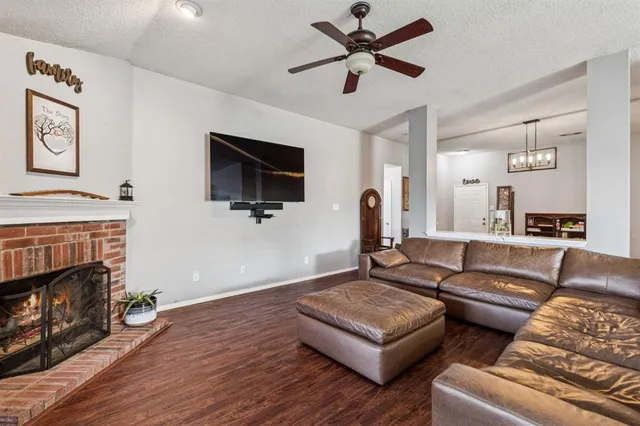 a living room with furniture a flat screen tv and a fireplace