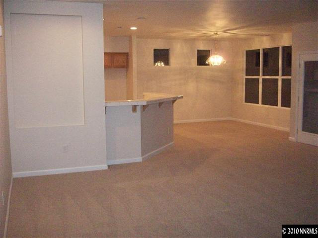 9668 Rolling Rock Way Reno, NV 89521 - Photo 3 of 9 a view of an empty room with windows and cabinet