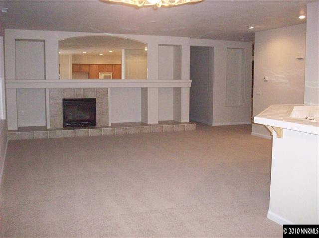 9668 Rolling Rock Way Reno, NV 89521 - Photo 5 of 9 a view of a livingroom with an empty space and a fireplace