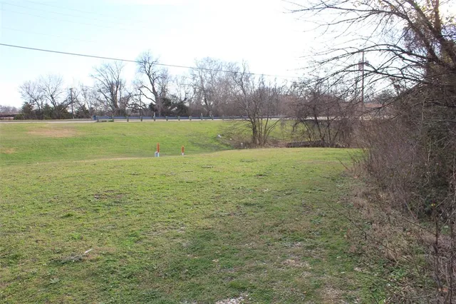 a view of outdoor space with yard and trees all around
