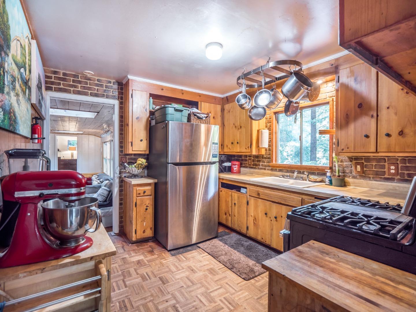 10970 Riverside Road Brookdale, CA 95005 - Photo 17 of 27 a kitchen with stainless steel appliances granite countertop a stove a refrigerator and a wooden cabinets