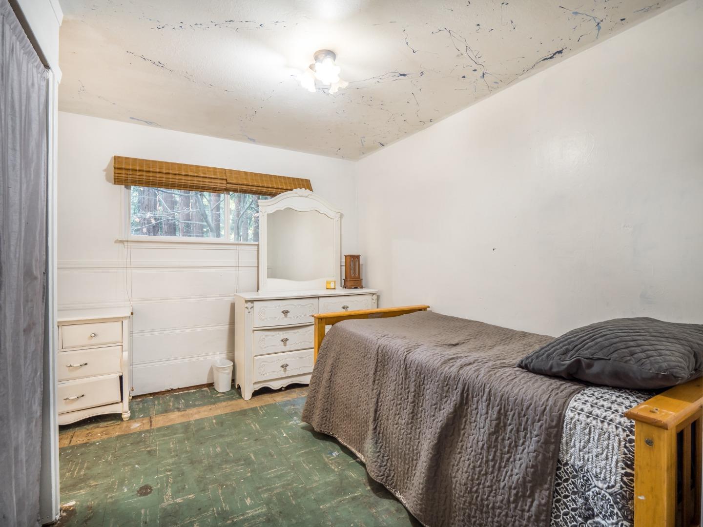 10970 Riverside Road Brookdale, CA 95005 - Photo 19 of 27 a bedroom with a bed and a cabinets