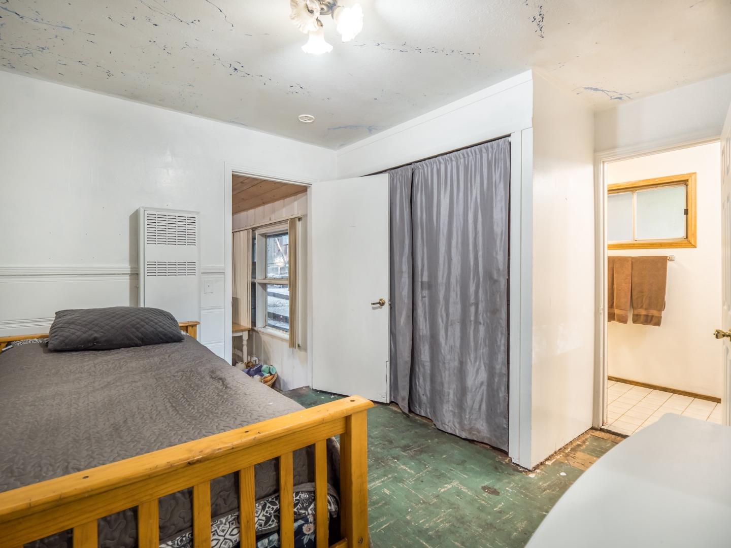 10970 Riverside Road Brookdale, CA 95005 - Photo 20 of 27 a bedroom with a bed and a window