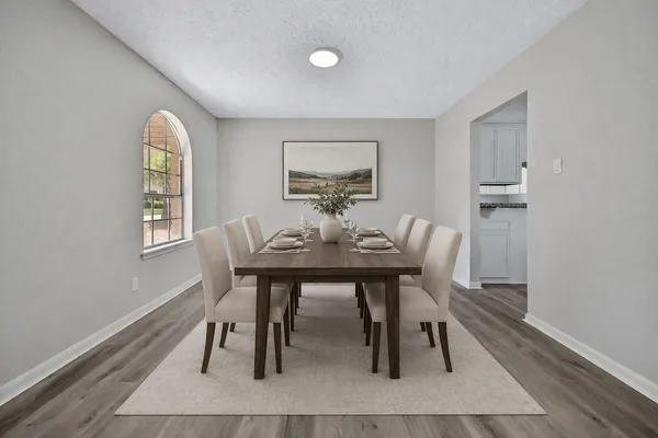 a view of empty room with wooden floor and window