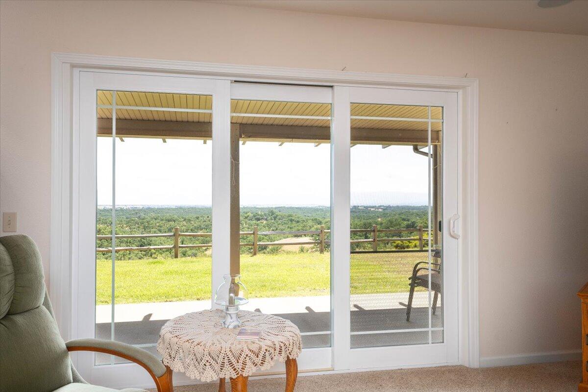 19035 Bonita Road Red Bluff, CA 96080 - Photo 15 of 55 a view of a bedroom with a large window and a porch
