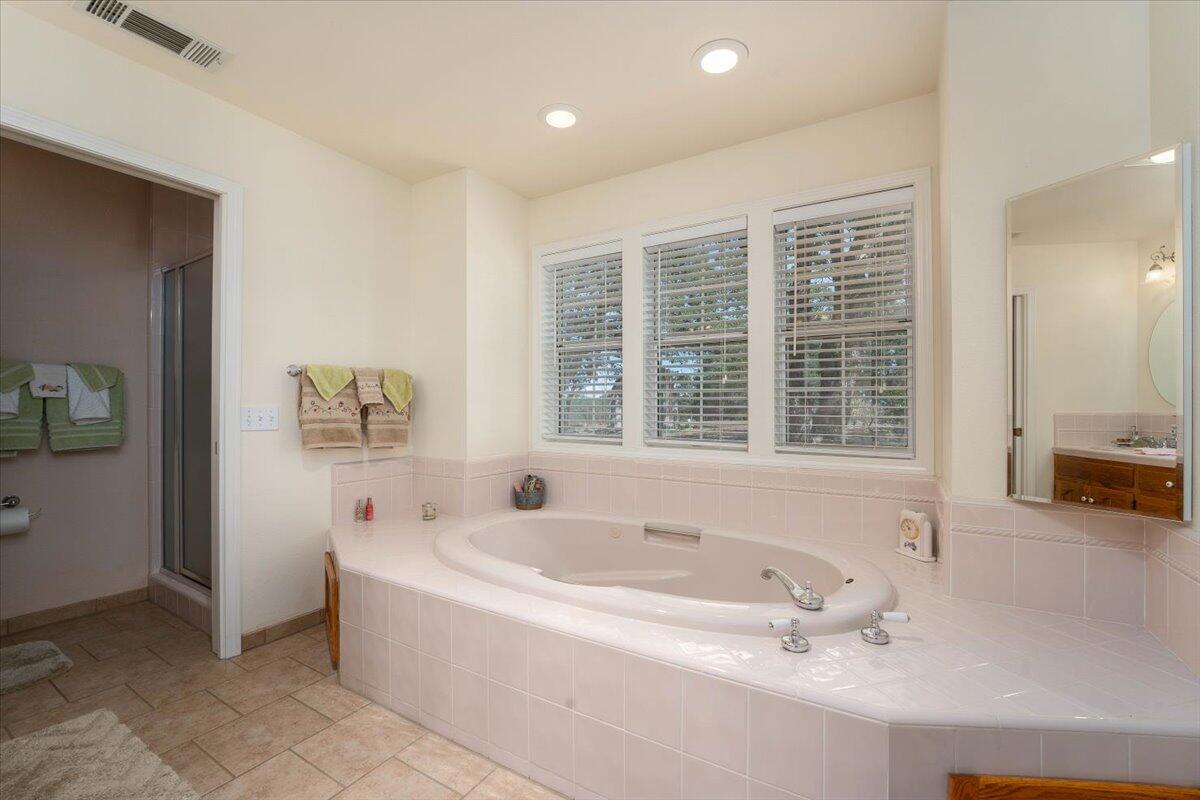 19035 Bonita Road Red Bluff, CA 96080 - Photo 25 of 55 a white bath tub sitting in a bathroom