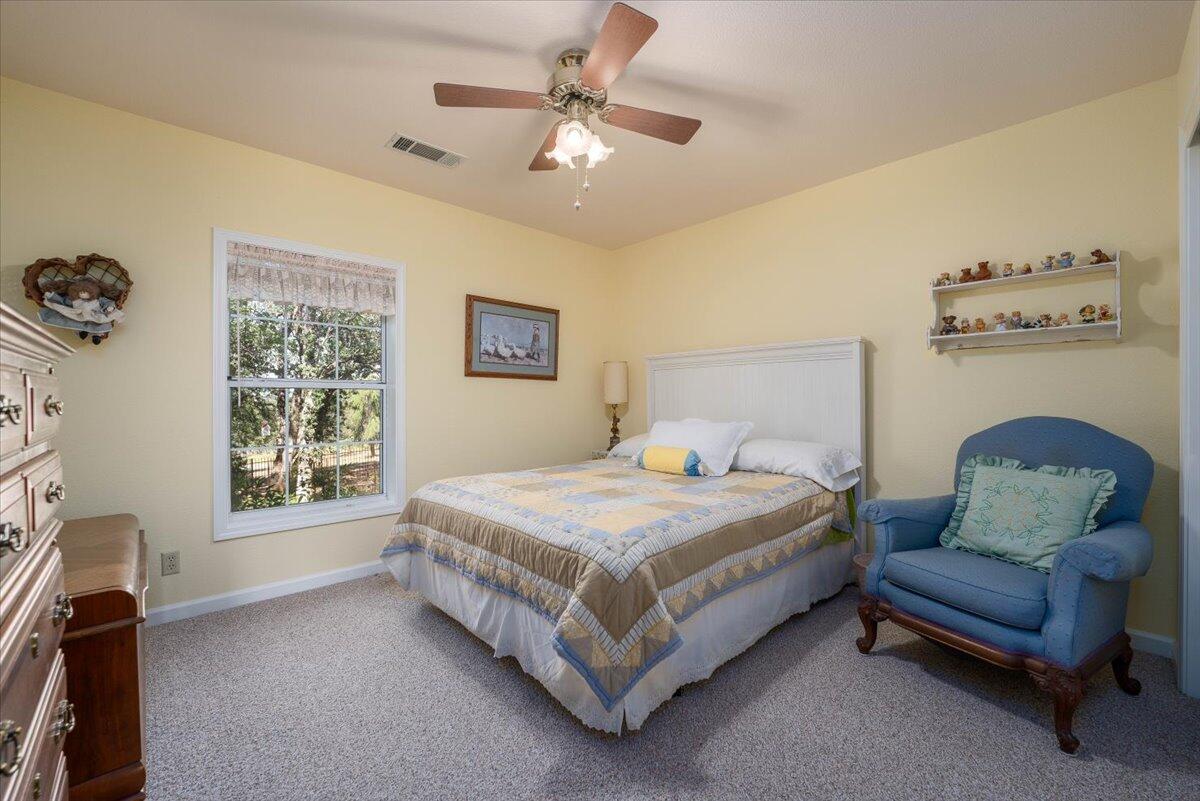 19035 Bonita Road Red Bluff, CA 96080 - Photo 27 of 55 a bedroom with a bed a couch and a window