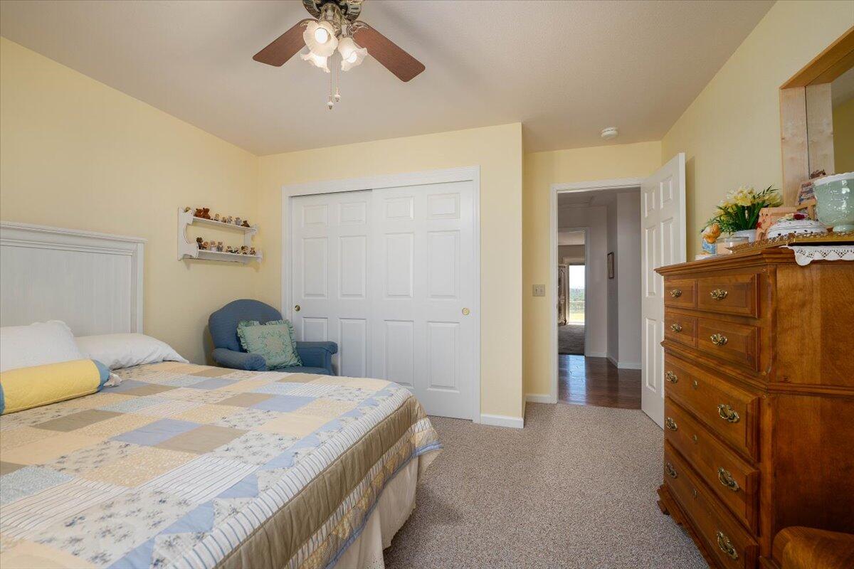 19035 Bonita Road Red Bluff, CA 96080 - Photo 28 of 55 a bedroom with a bed and a chandelier