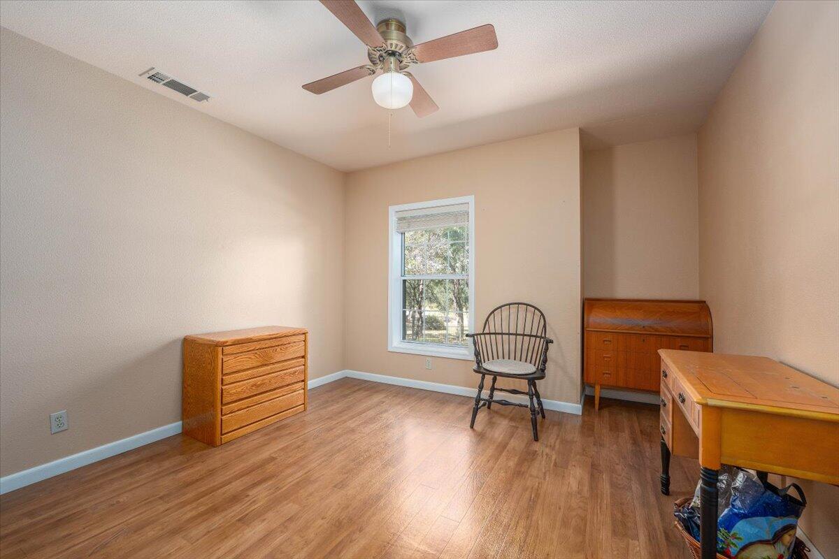 19035 Bonita Road Red Bluff, CA 96080 - Photo 31 of 55 a room with furniture and wooden floor