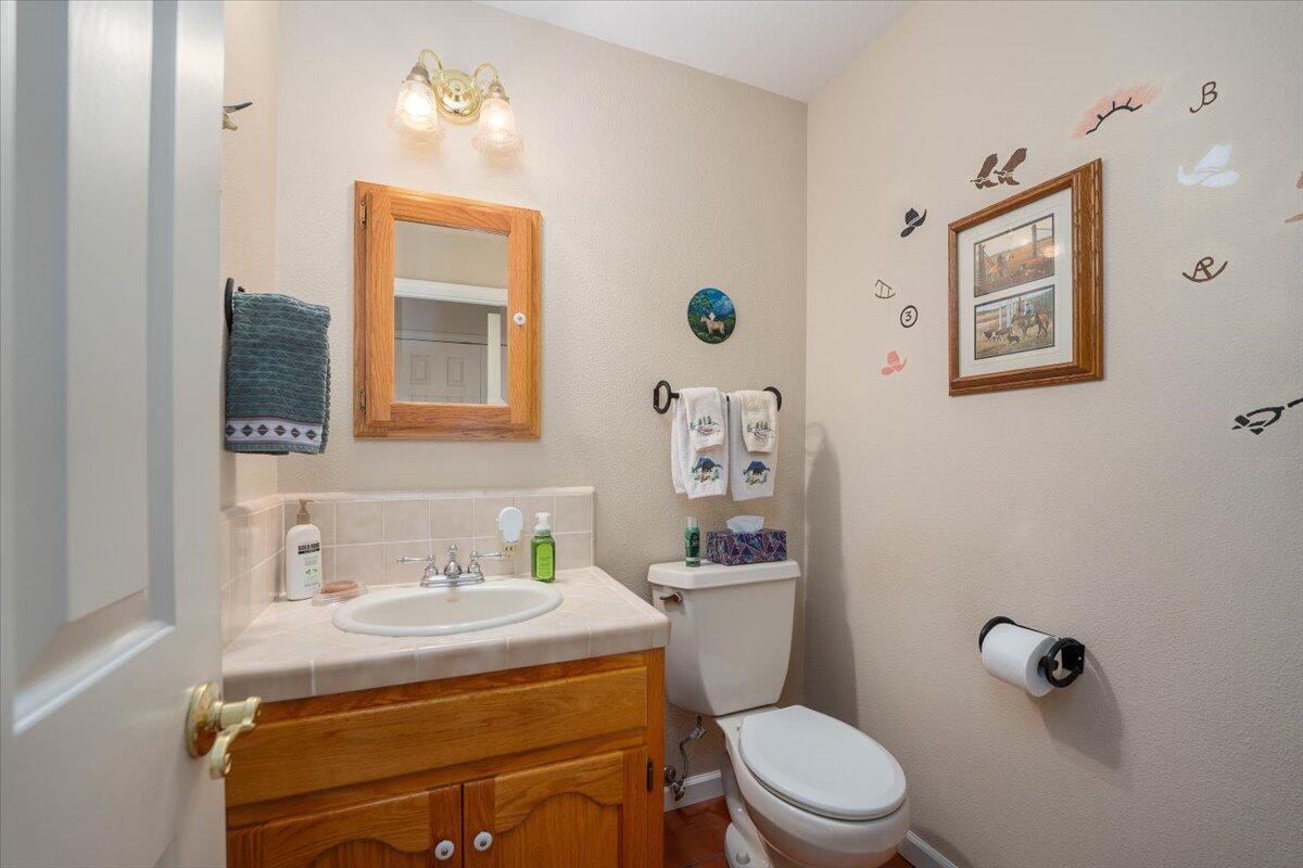 19035 Bonita Road Red Bluff, CA 96080 - Photo 33 of 55 a bathroom with a sink mirror vanity and toilet