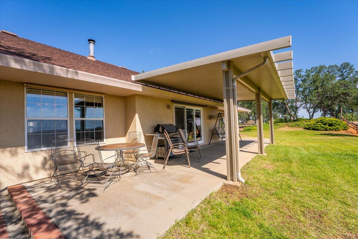 19035 Bonita Road Red Bluff, CA 96080 - Photo 36 of 55 a view of a patio with table and chairs near a barbeque