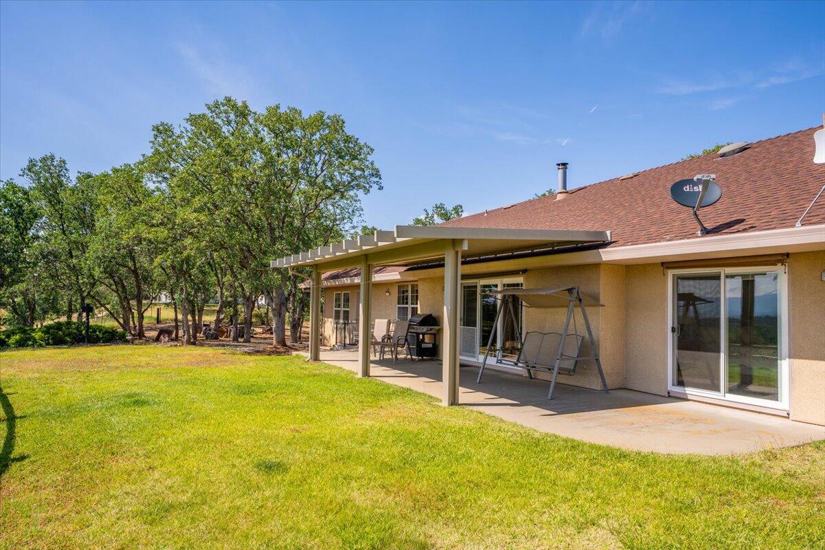 19035 Bonita Road Red Bluff, CA 96080 - Photo 37 of 55 a view of a patio with a table and chairs under an umbrella