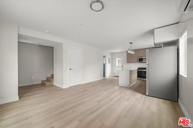 a kitchen with granite countertop a stove and a refrigerator