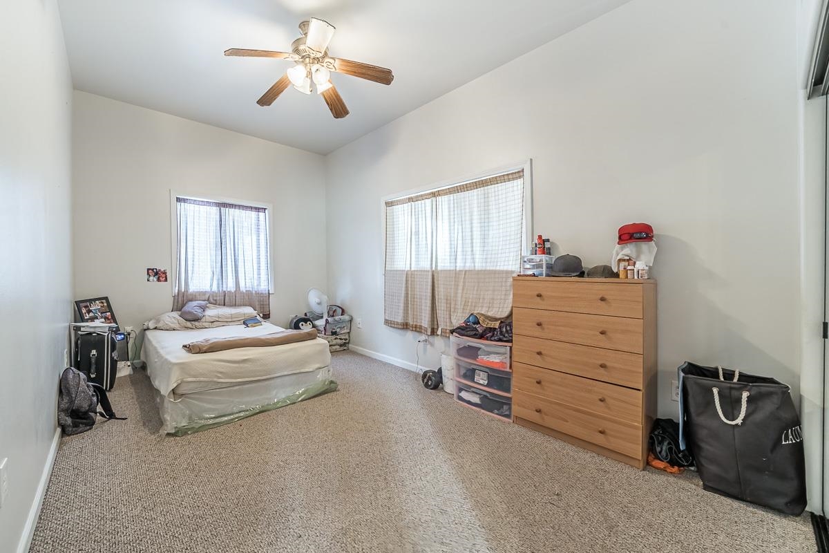 2640 Puuomalei Road Haiku, HI 96708 - Photo 26 of 30 a bedroom with a bed and a chandelier