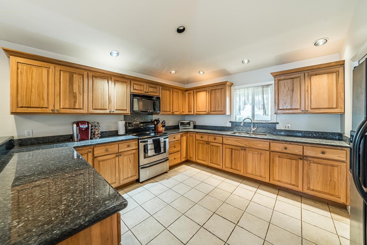 2640 Puuomalei Road Haiku, HI 96708 - Photo 6 of 30 a kitchen with stainless steel appliances granite countertop a stove sink and cabinets
