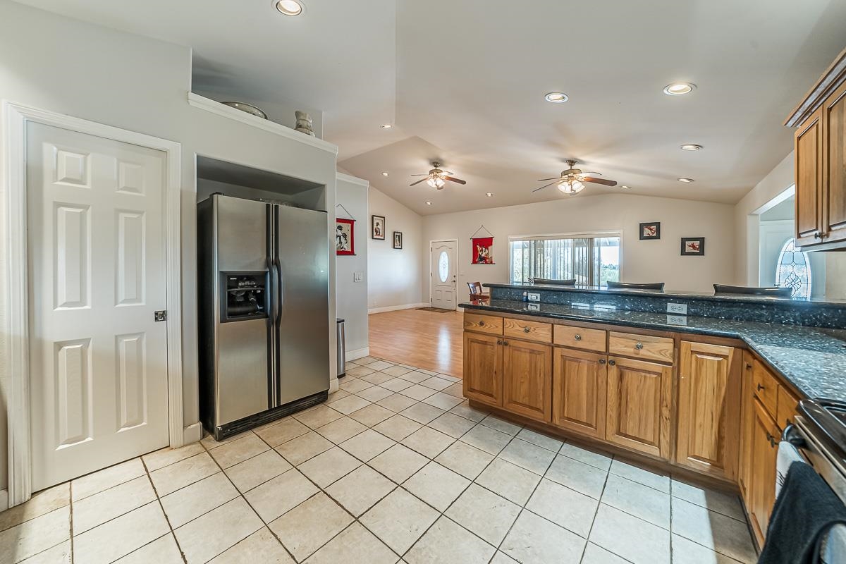 2640 Puuomalei Road Haiku, HI 96708 - Photo 7 of 30 a large kitchen with stainless steel appliances granite countertop a refrigerator and a sink