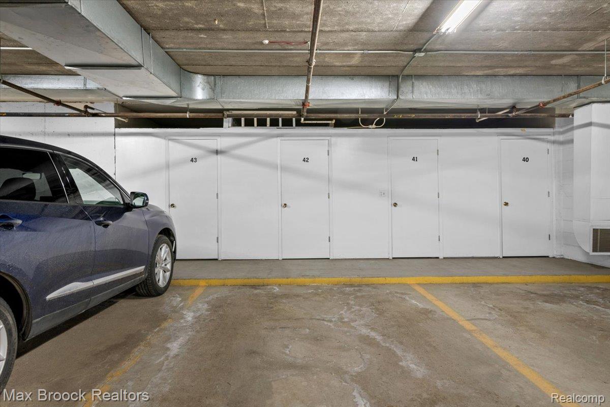 969 GreenView Court, Unit 42 Rochester, MI 48307 - Photo 30 of 41 Garage featuring a parking garage