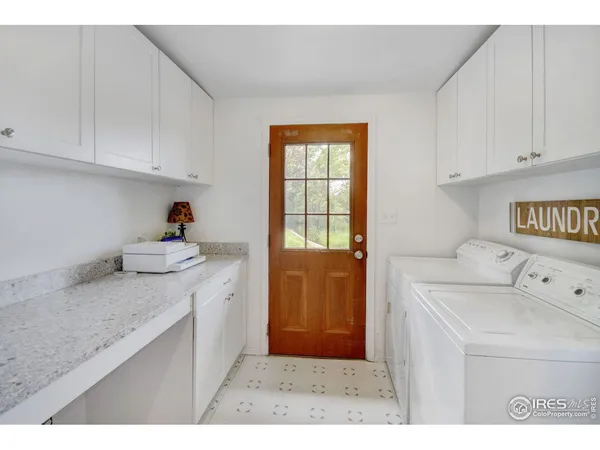 a kitchen with a sink a stove and cabinets