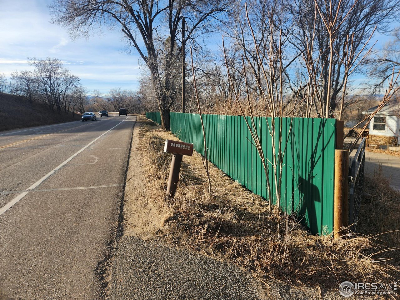 6903 Valmont Road Boulder, CO 80301 - Photo 25 of 44 Installation of new Valmont Road fencing is in progress, highlighted by loden-green steel panels and sturdy metal posts professionally embedded in concrete.