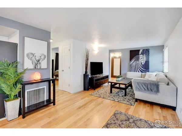 a bedroom with furniture and a flat screen tv