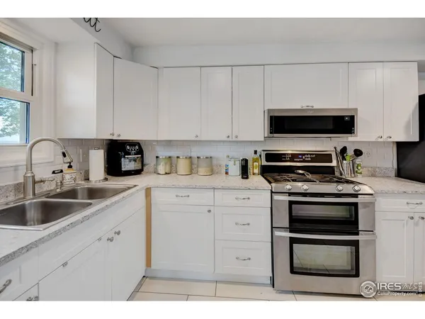 a kitchen with appliances a sink and a microwave
